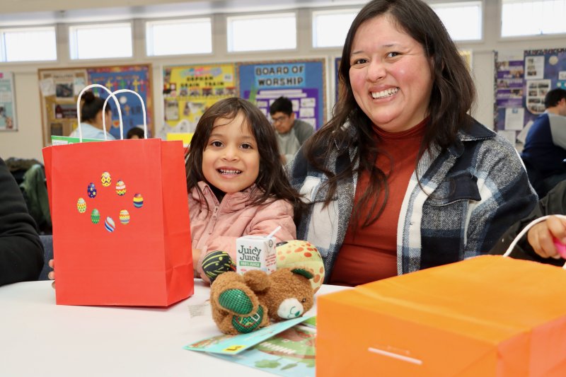 Angela Pacheco, left, and Lizeth Sanchez claimed a bag full of goodies after the egg hunt.